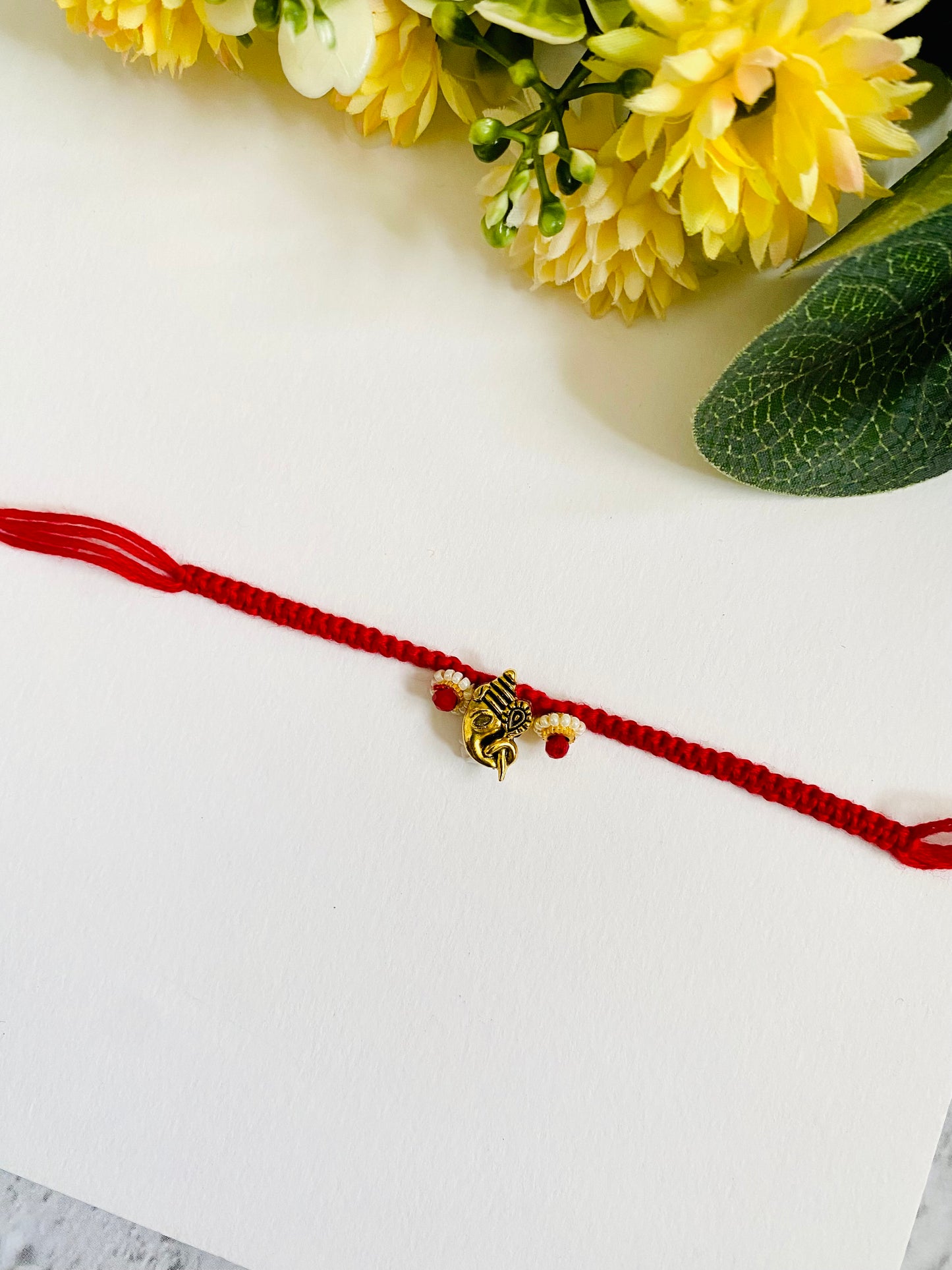 SIde Face Ganpati Knotted Bhai Rakhi