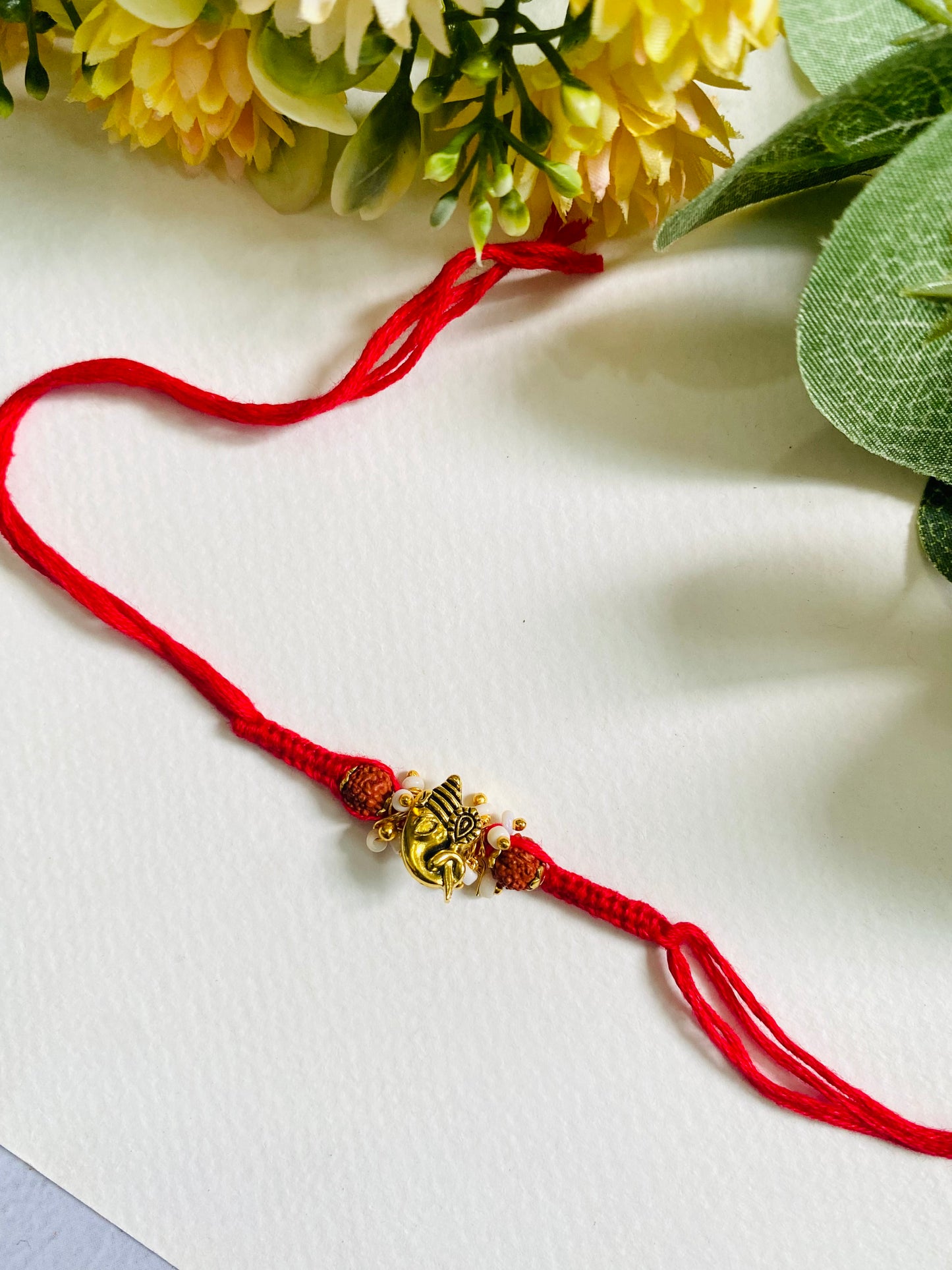 Side Face Ganpati Knotted Bhabhi Rakhi